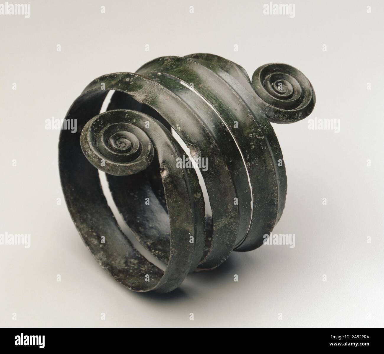 Turned Armilla, c. 1500 BC. Europe. As the spiral mimics forms found in nature - specifically in nautilus shells - it is the basis for logarithmic measures of progression in measurement and growth, which in turn help establish the Fibonacci sequence. Through this sequence we can analyze the phenomenon of spiral designs, specifically in nautilus shells, where the radius of each new chamber grows at a rate determined by a specific proportion to the previous one. Stock Photo