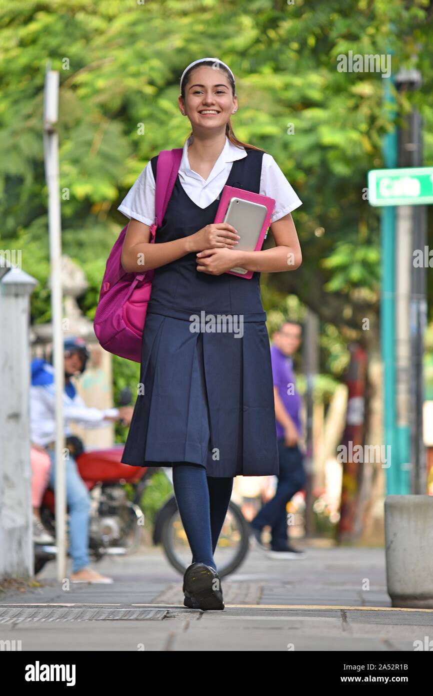 High School Girl Walking On Sidewalk Stock Photo - Alamy