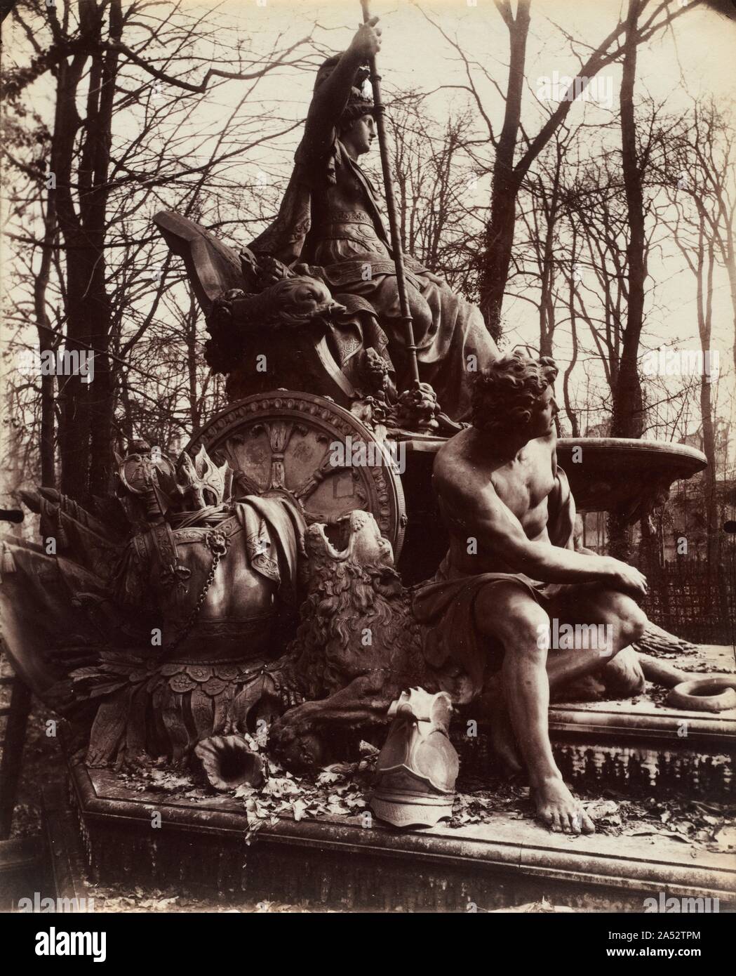 Versailles, Fountain of Triumphant France, 1904. From 1901 until his death in 1927, Atget devoted much of his time to documenting ch&#xe2;teaus and parks in and around Paris. Initially and most frequently, he was attracted to the gardens of Versailles, first working there until 1906. This intriguing detail of the Fountain of Triumphant France isolates two of its three allegorical figures: the seated representation of the French Empire behind Jean-Baptiste Tubi&#x2019;s sculpture denoting Spain. The fountain was commissioned by Louis XIV to celebrate the French victory over Spain and Holland. T Stock Photo