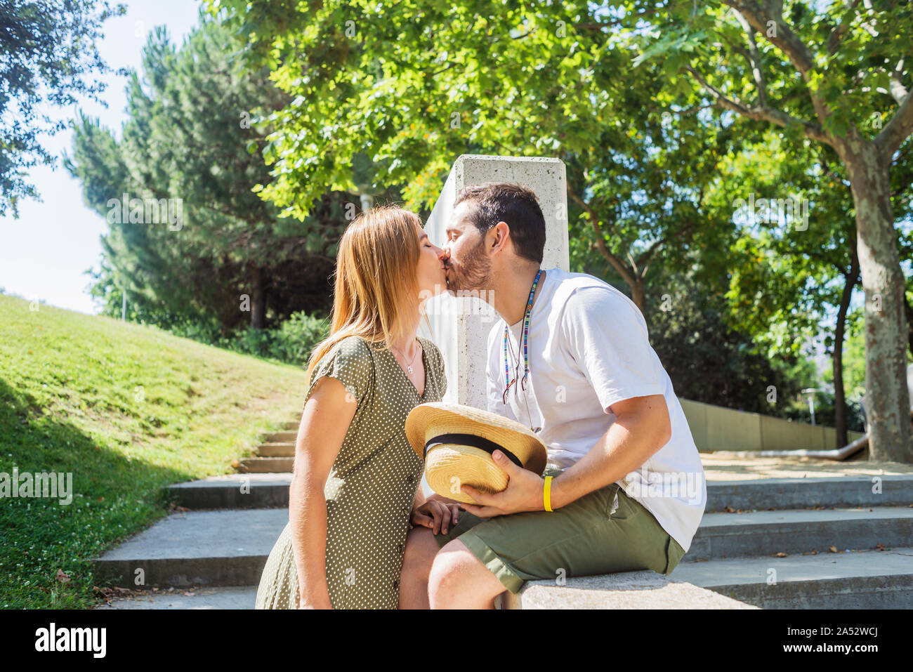 Young couple kissing on a park Stock Photo