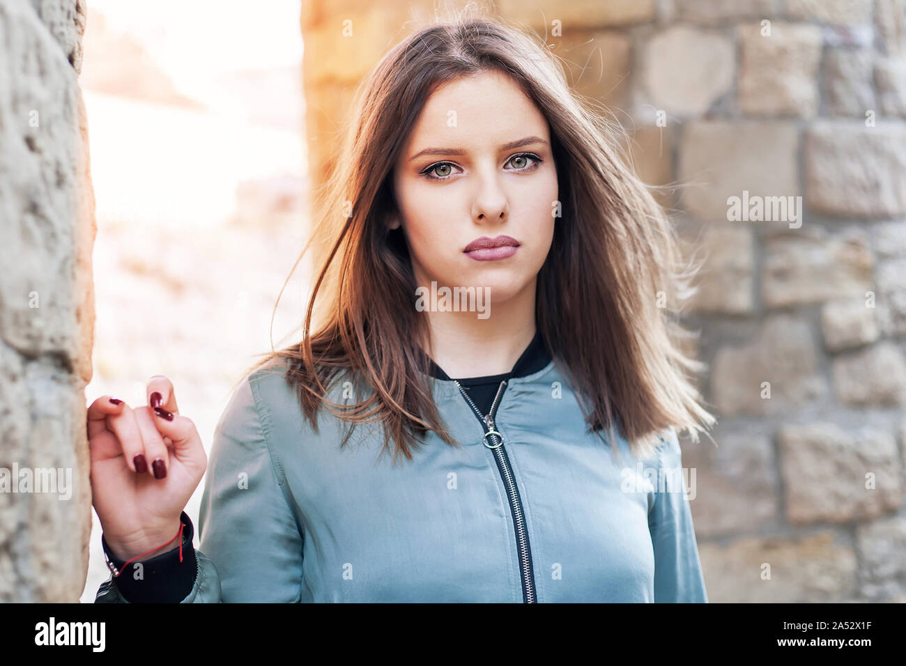 Girl with unhappy face in winter sunset Stock Photo