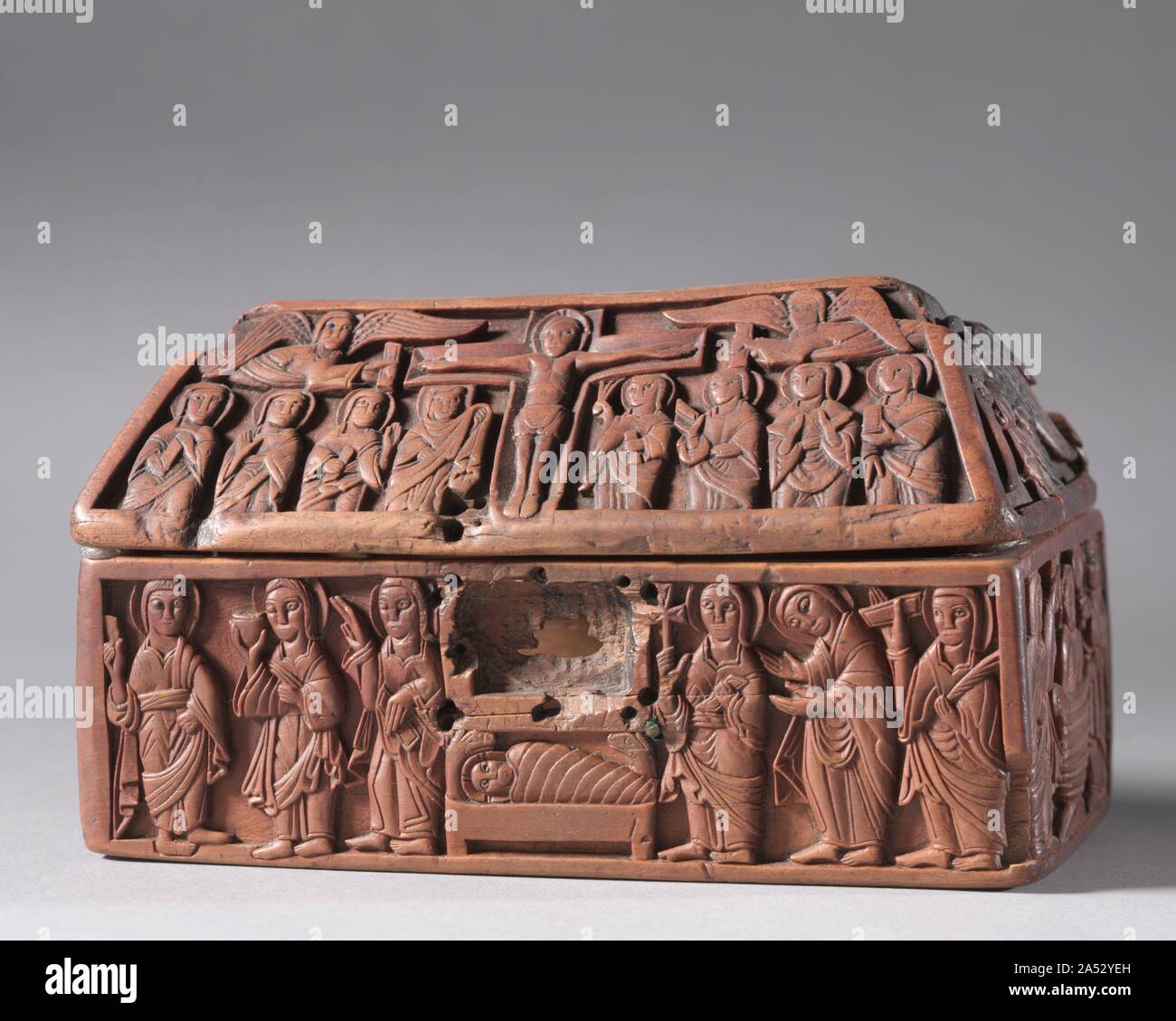 Wooden Casket: Scenes from the Life of Christ, c. 1050. This casket is a rare, if not unique example of high-quality woodcarving from Anglo-Saxon England. Decorated with scenes from Christ&#x2019;s life, it was likely made for an ecclesiastical purpose and may have housed relics. On one long side, the Christ child rests in the manger. Above, the Crucifixion is shown with mourners gathered below the cross and two angels flanking it on either side. On the other long side is the Ascension, God&#x2019;s hand pulling Christ heavenward. Christ in Majesty appears above. The short sides show Christ&#x Stock Photo