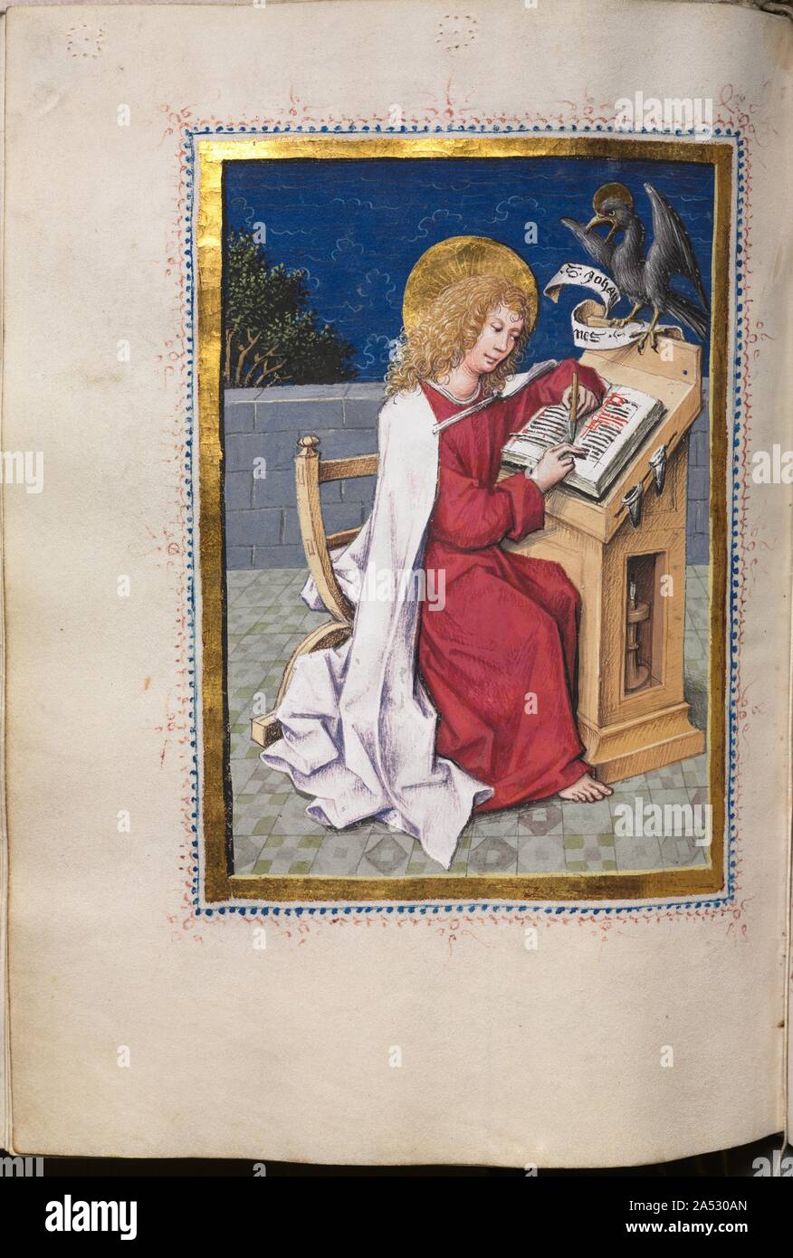 Gospel Book with Evangelist Portraits: Saint John, c. 1480. Each of the four gospels, here in Latin, are preceded by a full-page miniature of the appropriate Evangelist. As is conventional, the Evangelists are represented as contemporary scribes seated at a lectern surrounded by all the accouterments of the trade---inkpots, quill pens, penknives, etc. The miniatures style is characteristically German late Gothic in its expressive use of angular drapery and realistic detail. Each miniature, however, bears the marks of The Hausbuch Master's hand: notice the terrace space for each figure and the Stock Photo