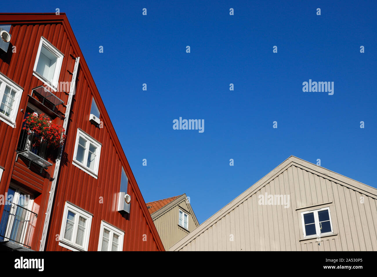 Partial view of multi story modern apartment buildings with a wooden facade. Stock Photo