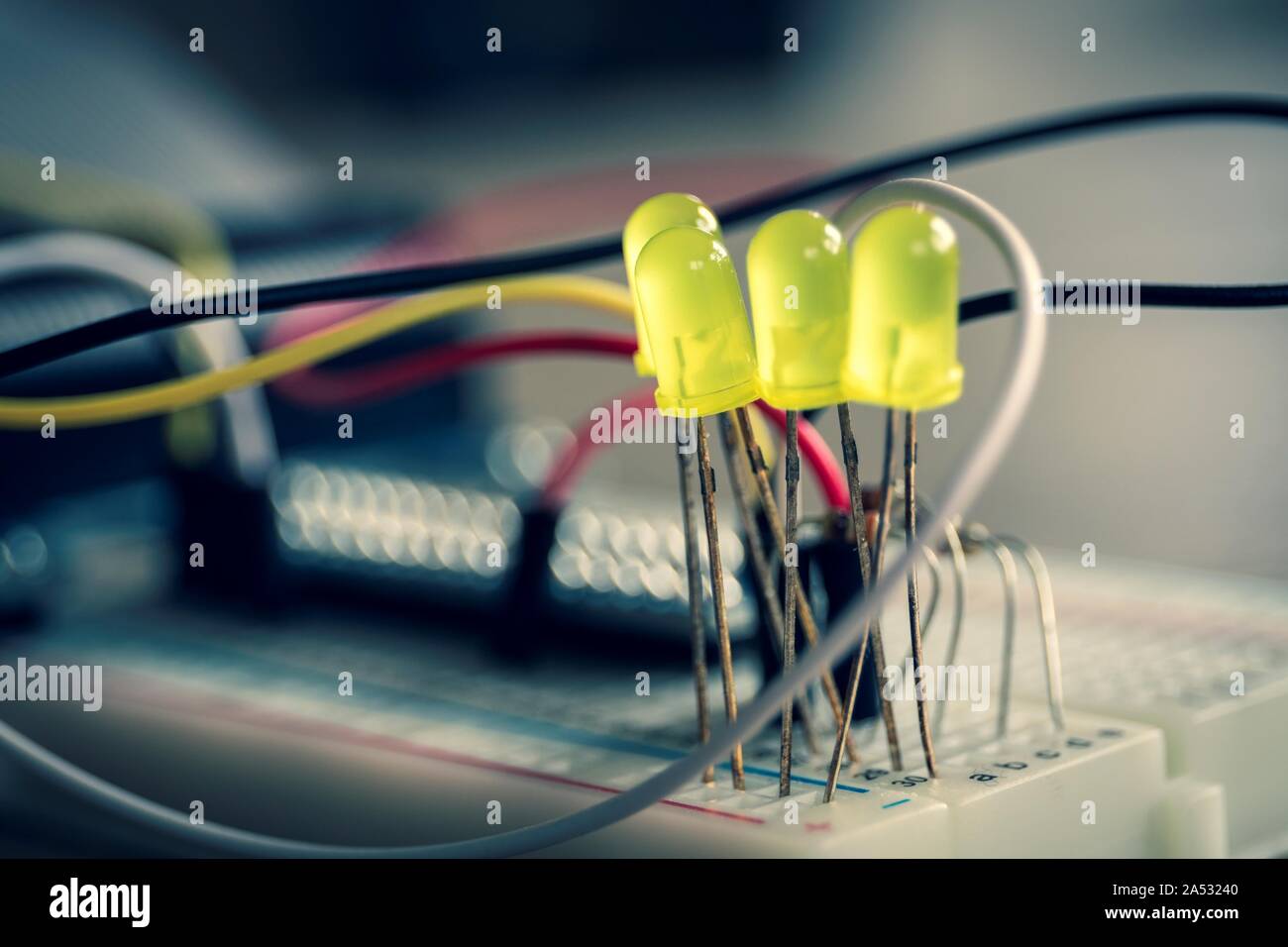 A portrait of an electronic circuit of LEDS on a breadboard with wires