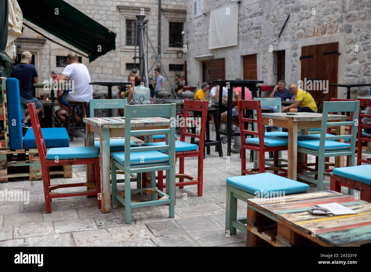 Montenegro, Sep 17, 2019: Urban scene with guests sitting at an outdoor cafe in the Old Town of Kotor Stock Photo