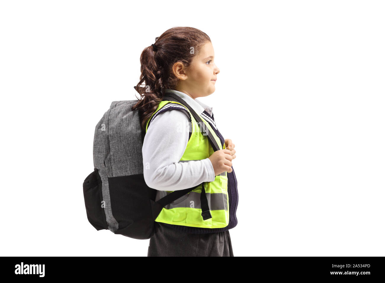 Schoolgirl with a safety vest standing isolated on white background Stock Photo