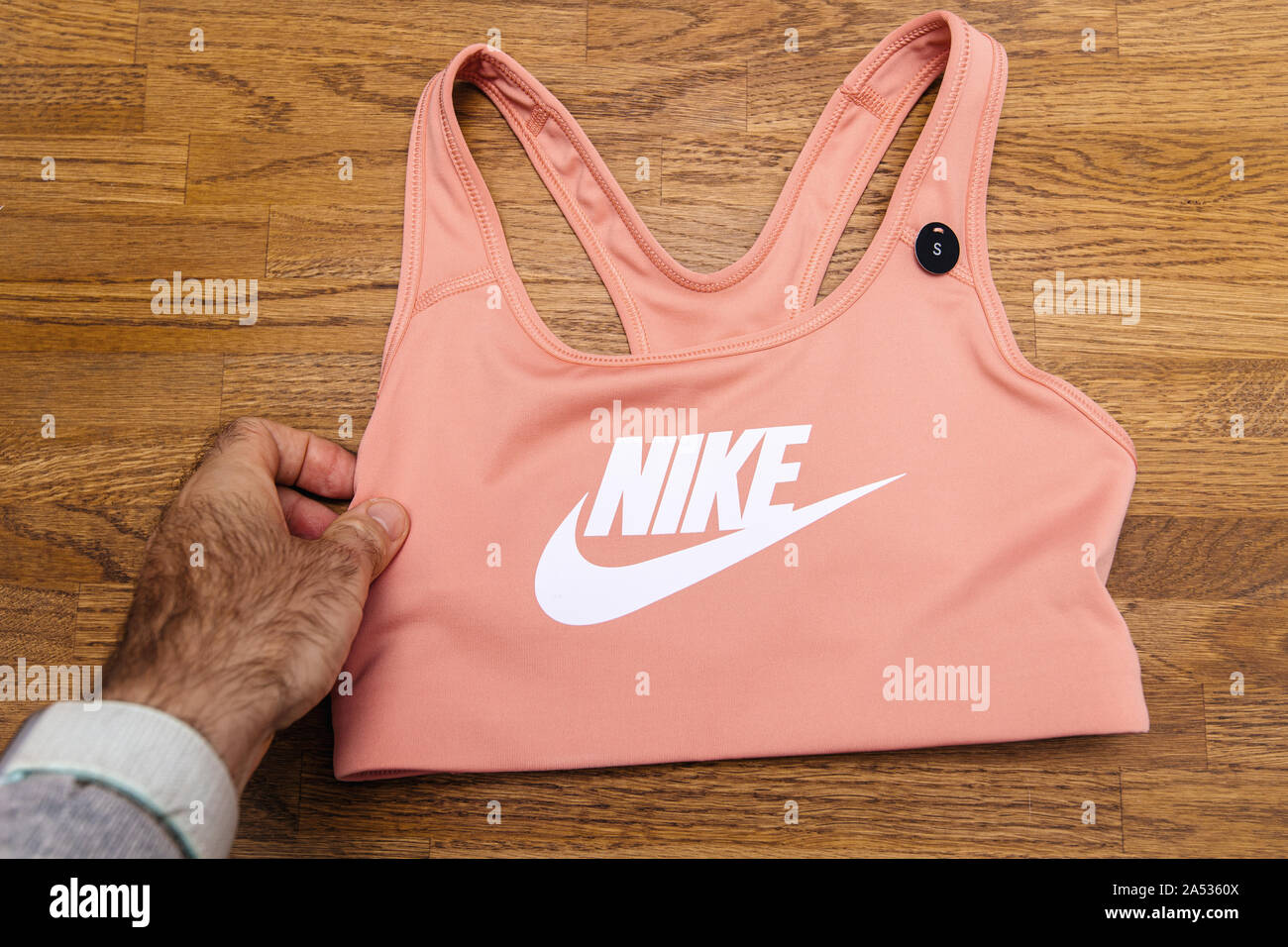 Paris, France - Oct 4, 2019: Man hand holding new female Nike Swoosh bra in  classic style and with versatile performance manufactured with Dri-Fit  technology Stock Photo - Alamy
