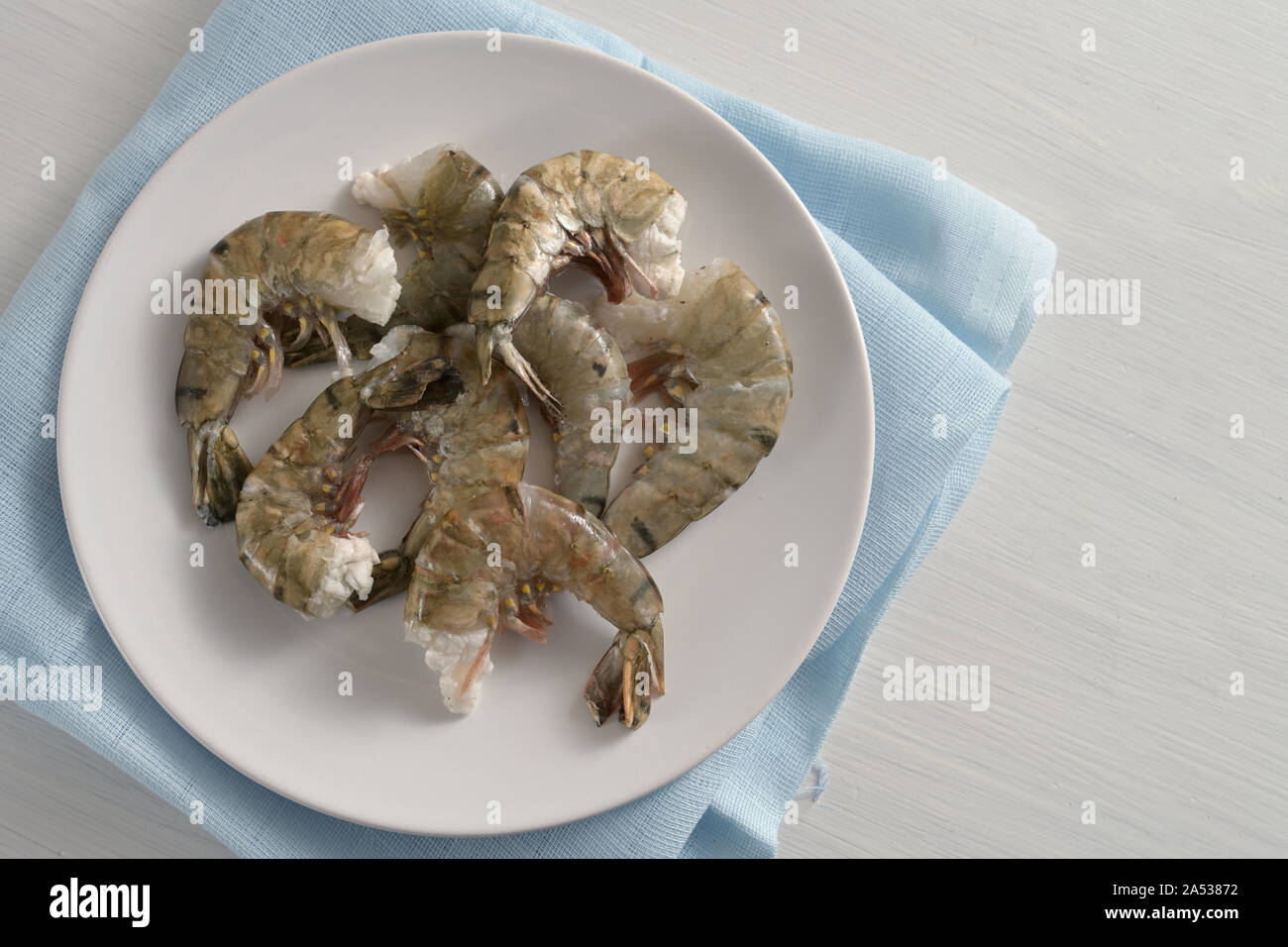 Raw black tiger prawn shrimps without head, fresh cooking ingredients for a tasty dish, copy space, high angle view from above Stock Photo