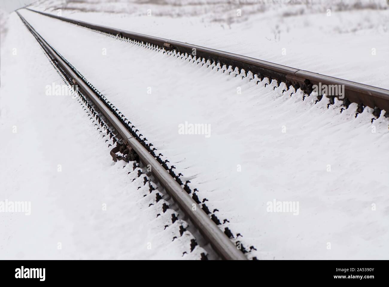 Railroad tracks covered by snow in a field. Landscape in the ...