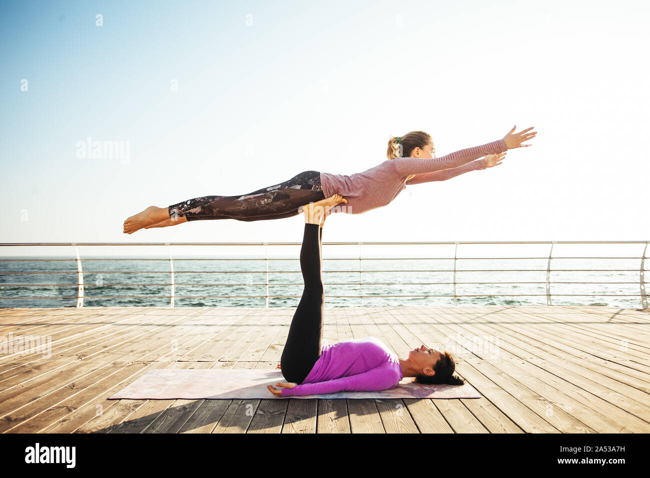Couple practicing acroyoga at morning Stock Photo