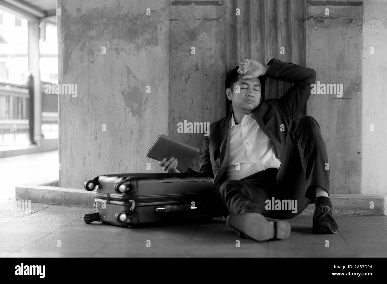 Stressed asian businessman bankrupt with sitting at outdoor. Stock Photo