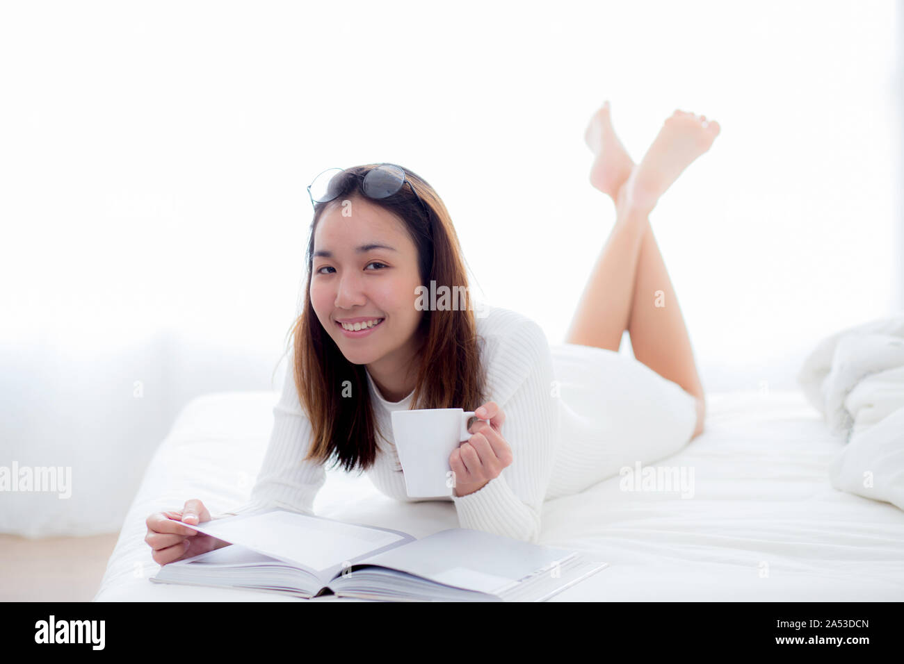 Young woman lying in bed and reading a book hi-res stock photography and  images - Page 3 - Alamy