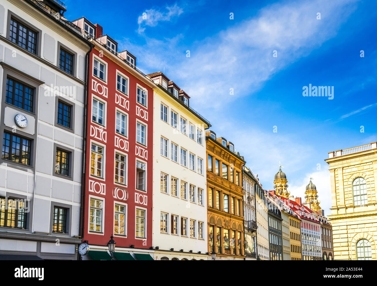 View on old houses in downtown Munich with theatiner Church in the back, Germany Stock Photo