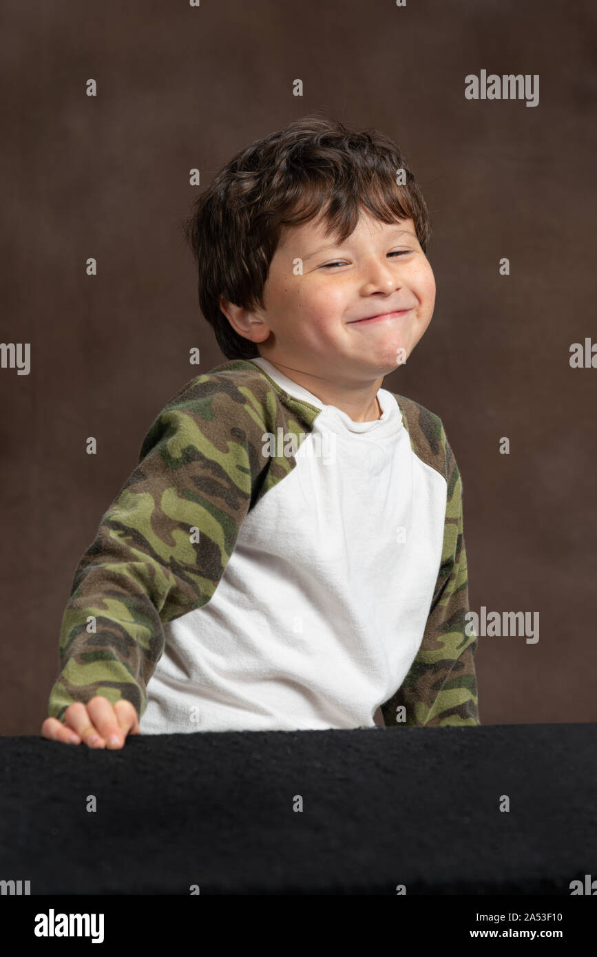 Vertical studio shot of a four-year-old little boy making a cute face. Stock Photo