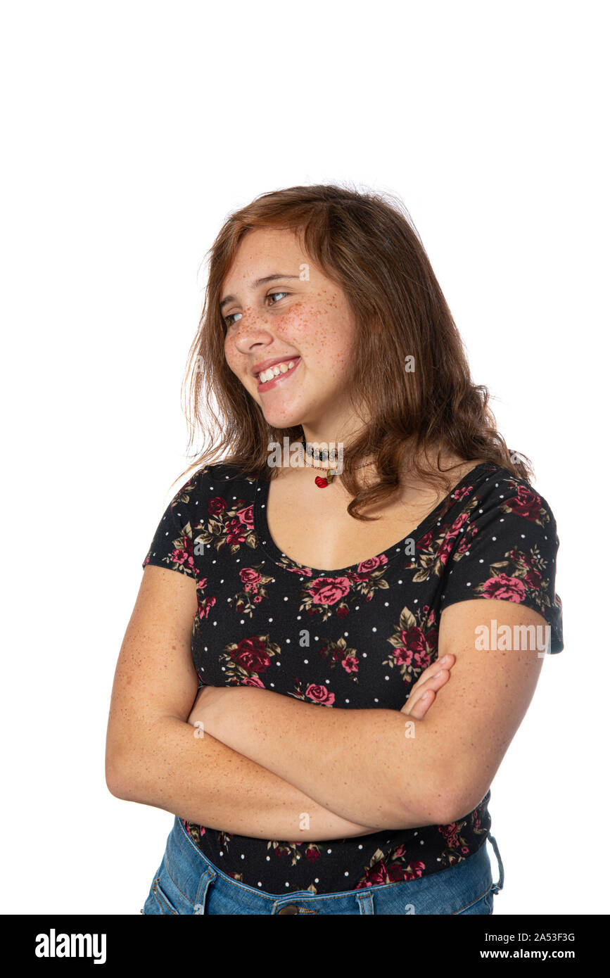 Vertical studio shot of a happy pre-teen girl isolated on white. Stock Photo