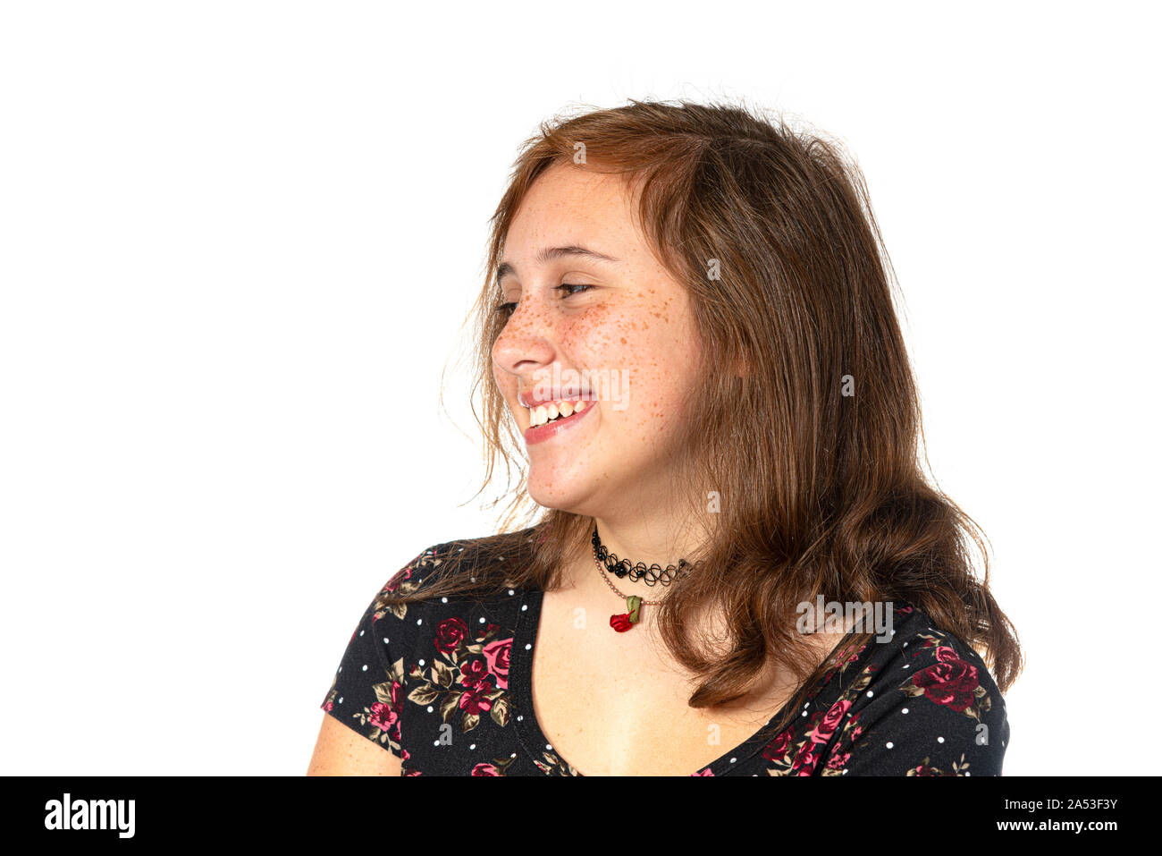 Horizontal studio shot of a happy pre-teen girl with freckles isolated on white. Stock Photo