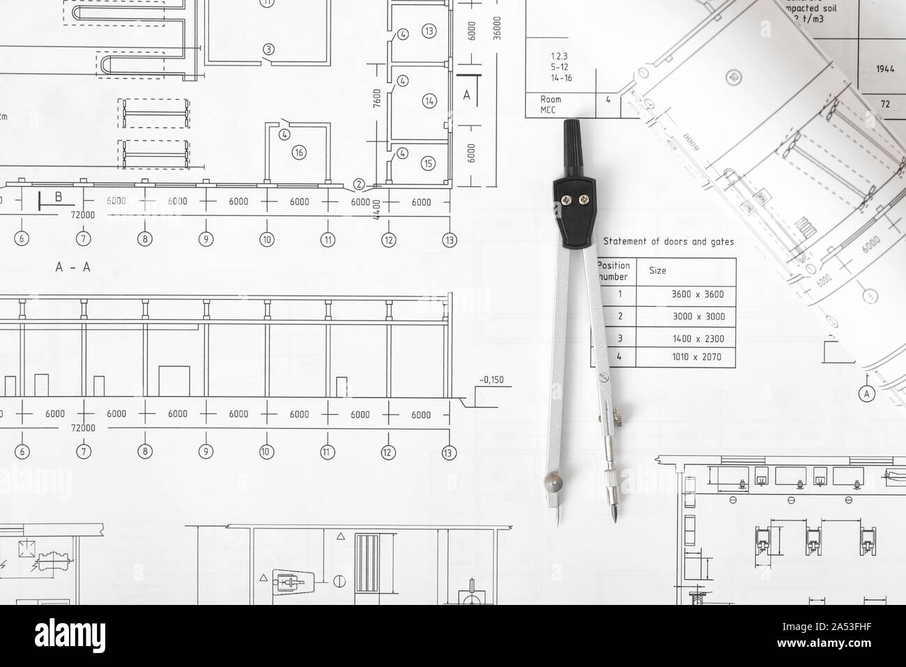 Engineering compass is on building plan Stock Photo Alamy