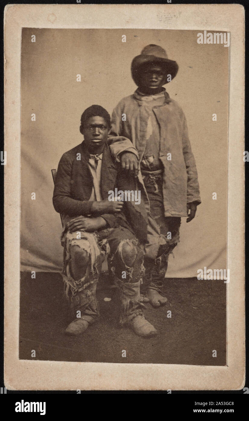 Two unidentified escaped slaves wearing ragged clothes] / Photographed by McPherson & Oliver, Baton Rouge, La Stock Photo