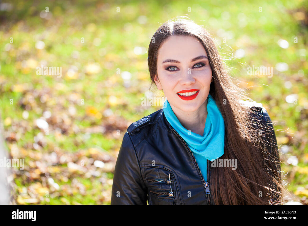 Portrait Of Beautiful Young Brunette Woman In Black Leather Jacket Hiding  Face Behind Yellow Autumn Maple Leaf Stock Photo, Picture and Royalty Free  Image. Image 10944590.