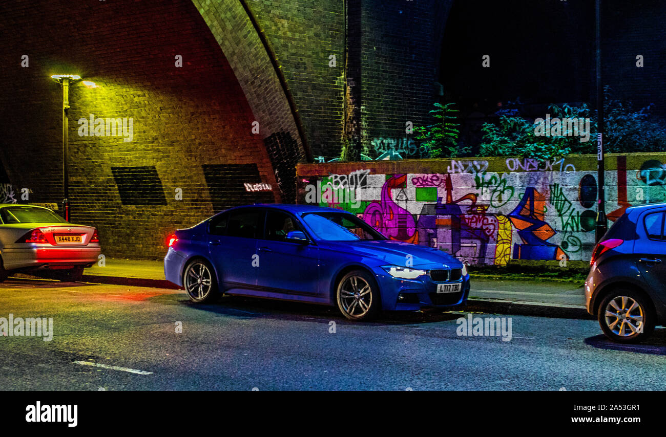 BMW 3 series in front of graffiti Stock Photo