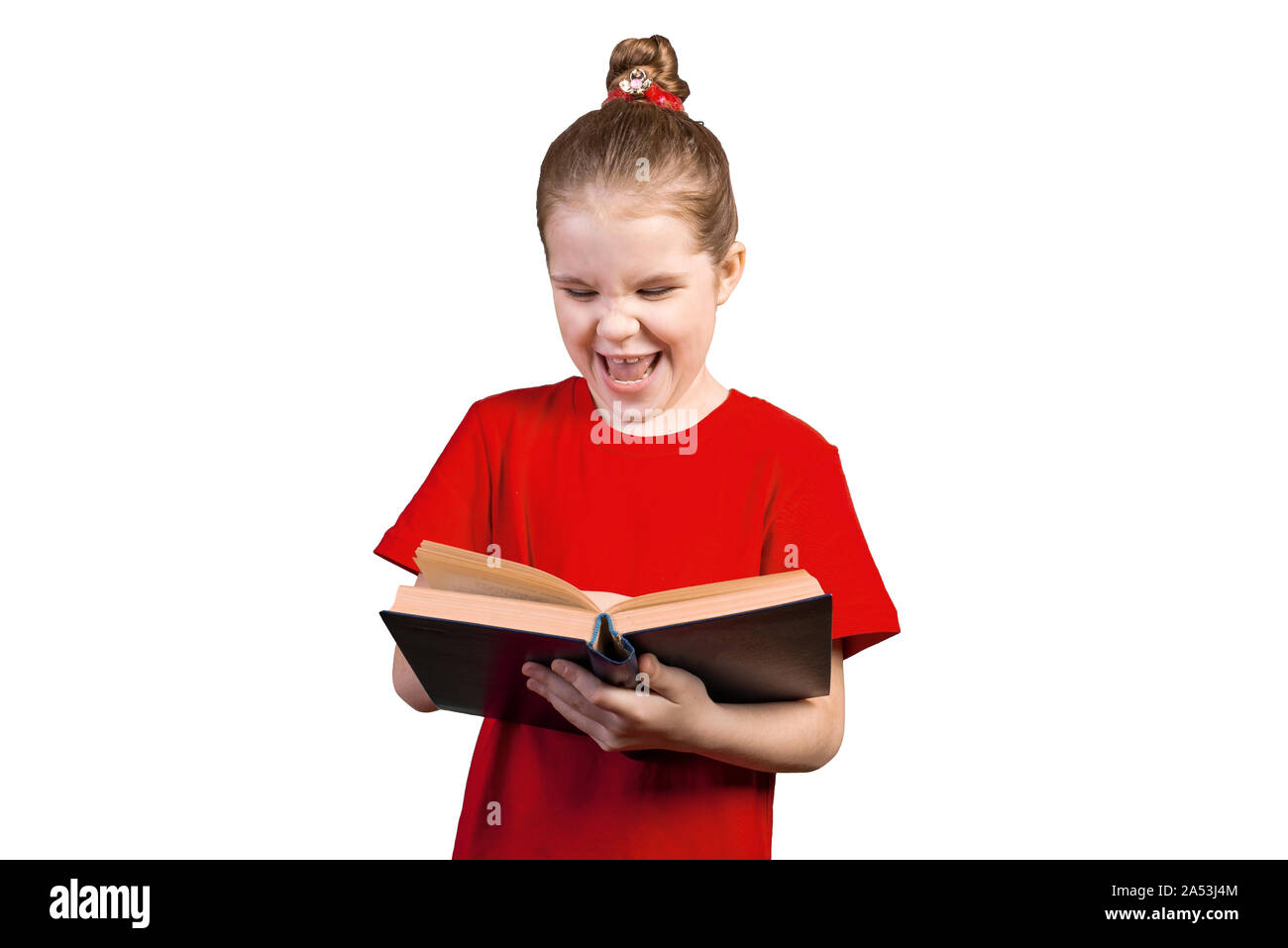 Little girl is laughing reading an old book. Isolated on a white background. Stock Photo