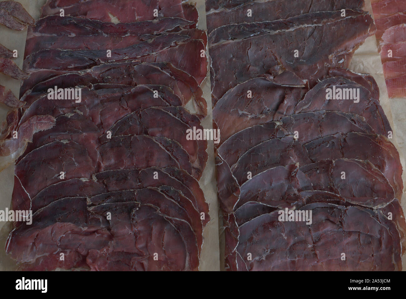 Sliced cured bresaola. Bresaola Italian beef jerky. Sliced beef