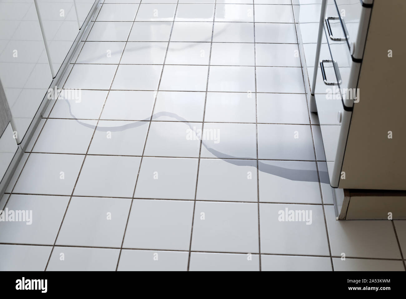 Closeup Photo Of Flooded Floor In Kitchen From Water Leak In Broken