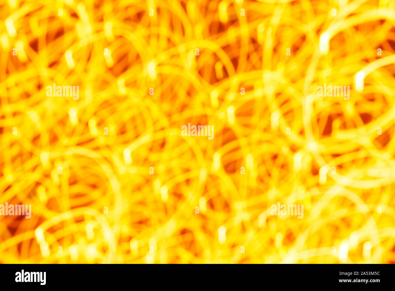 Futuristic blurred lights holiday monochrome background in yellow. Horizontal, soft focus Stock Photo