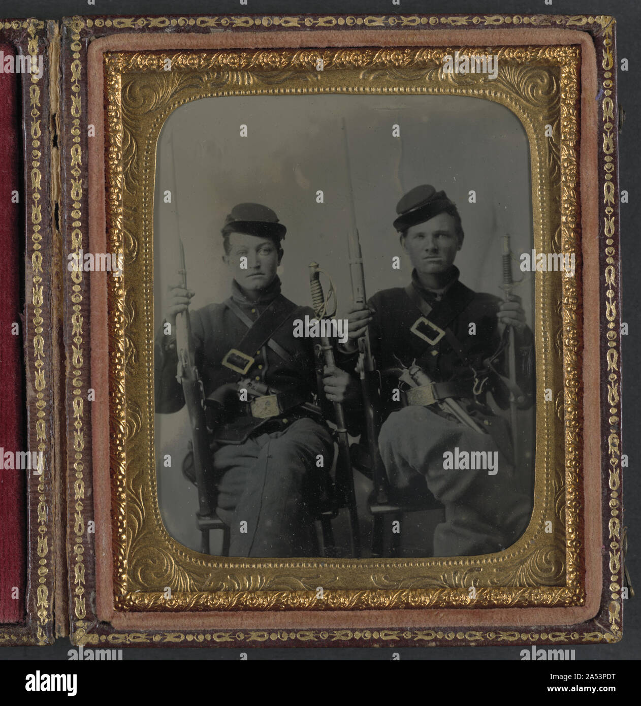 Two unidentified soldiers with Spencer carbines, 1860 sabers, and Colt Army revolvers, probably Union uniforms Stock Photo