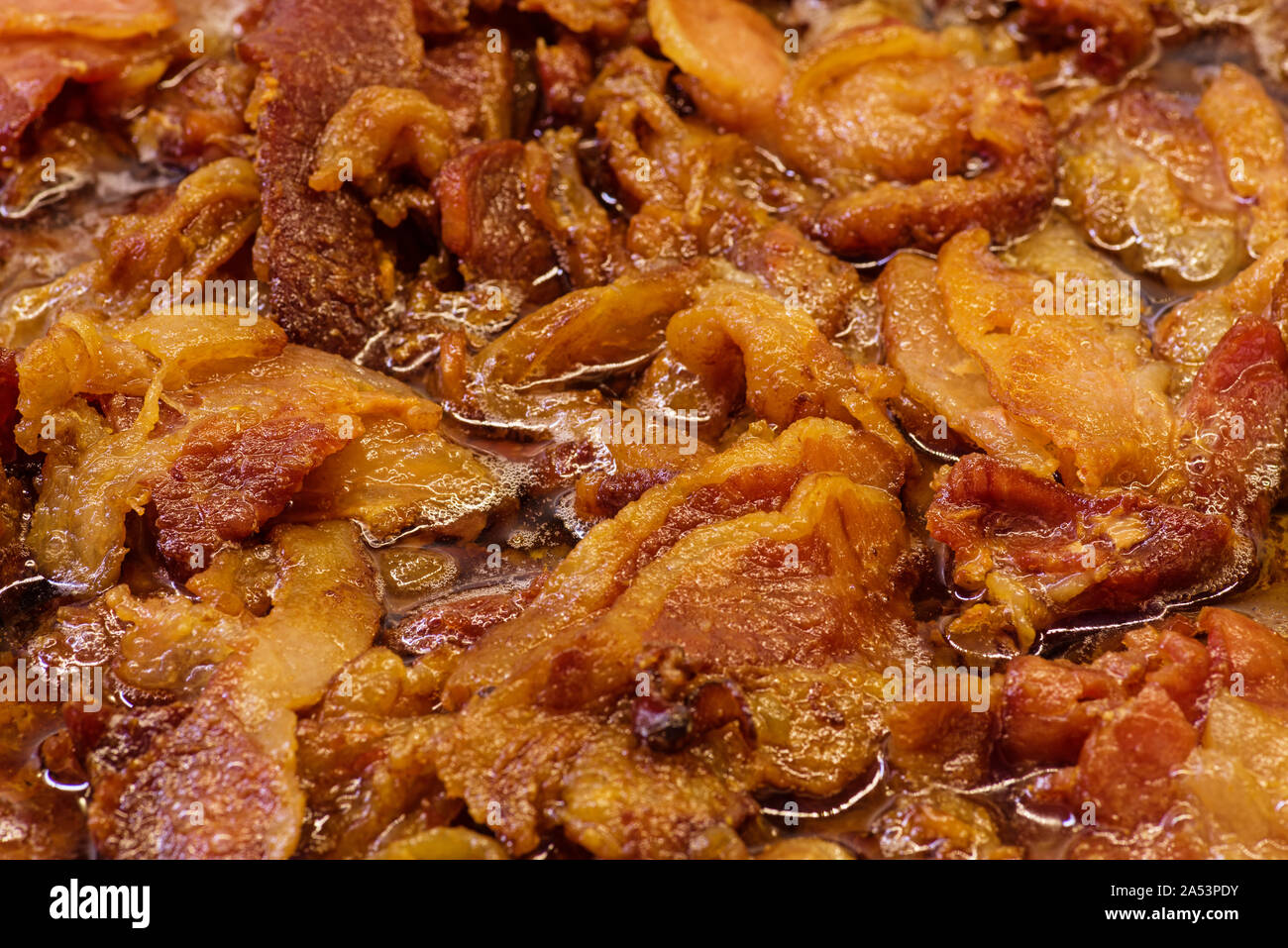 background of bacon ends frying in bacon grease Stock Photo