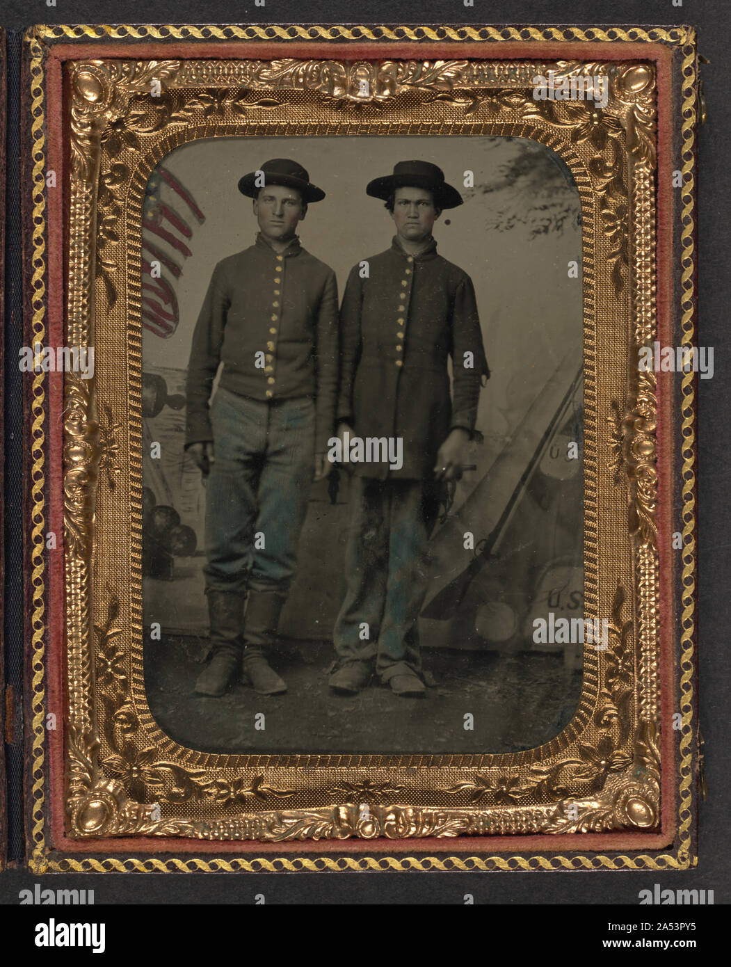 Two unidentified young soldiers in Union uniforms in front of painted ...
