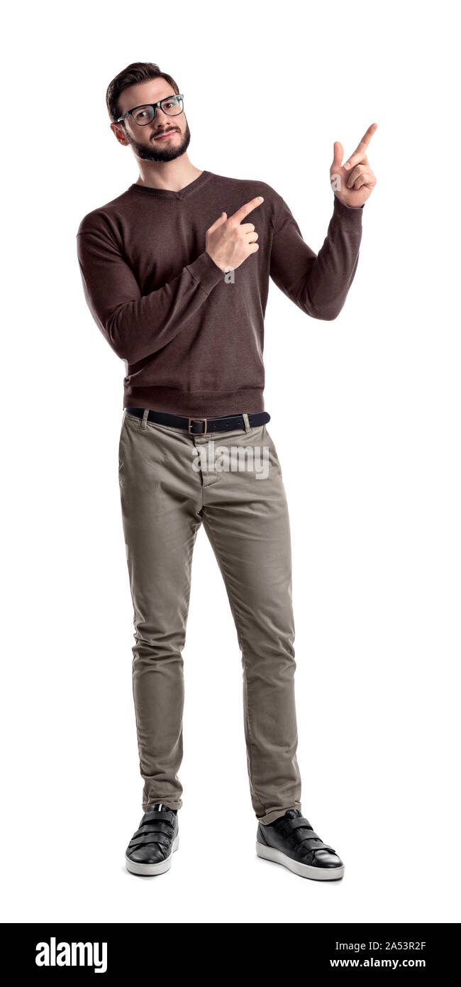 A bearded man in smart casual clothes looks in front to camera and points sideways with both hands and index fingers. Stock Photo