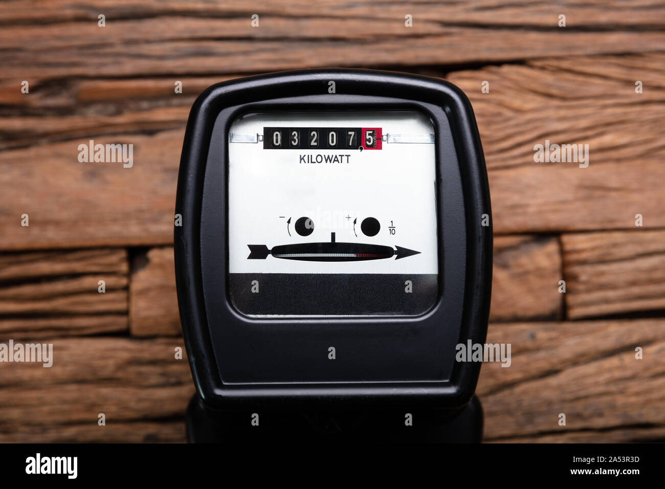 Close-up Of A Kilowatt Electricity Meter On Wooden Desk Stock Photo