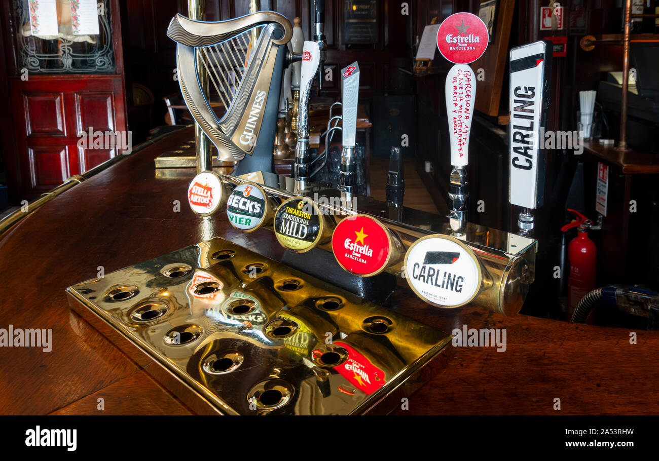 Draft or draught beer fonts in an English pub Stock Photo