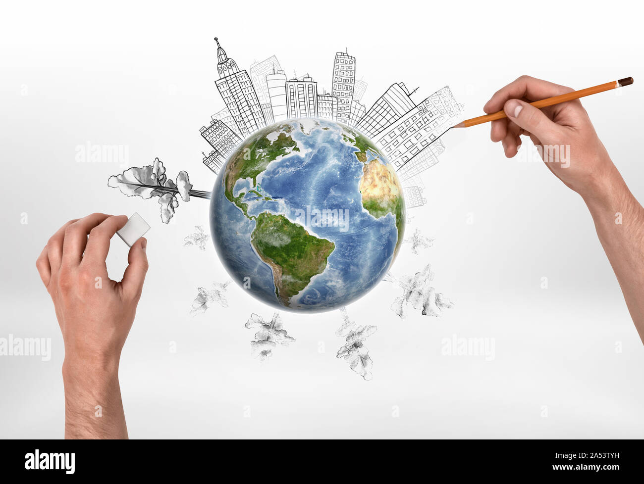 Hands of man drawing buildings and erasing trees on the globe. Stock Photo