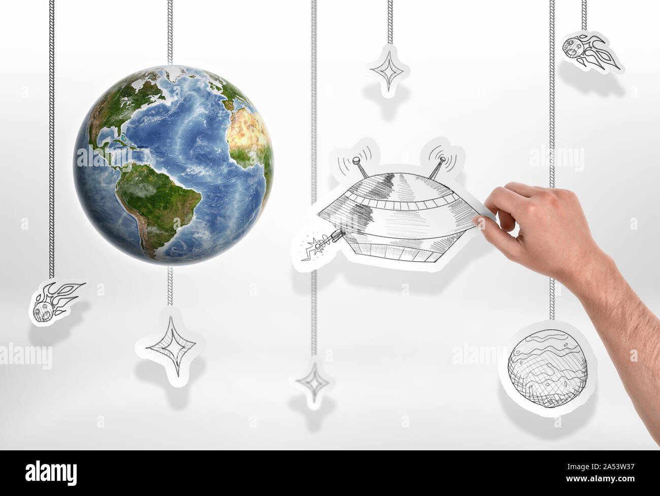 Earth with man's hand holding a picture of big UFO on the white background Stock Photo