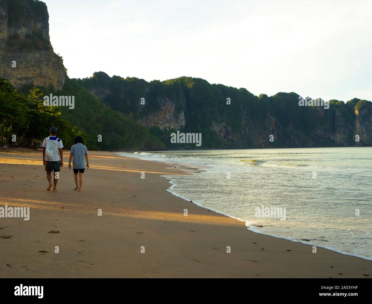 Couples walking on the beach Stock Photo