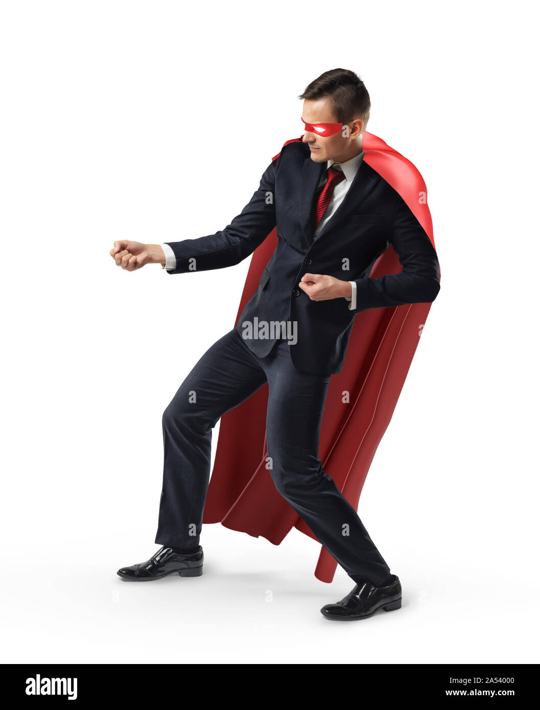 A businessman wearing a super hero mask and red cape holding an invisible rope. Stock Photo