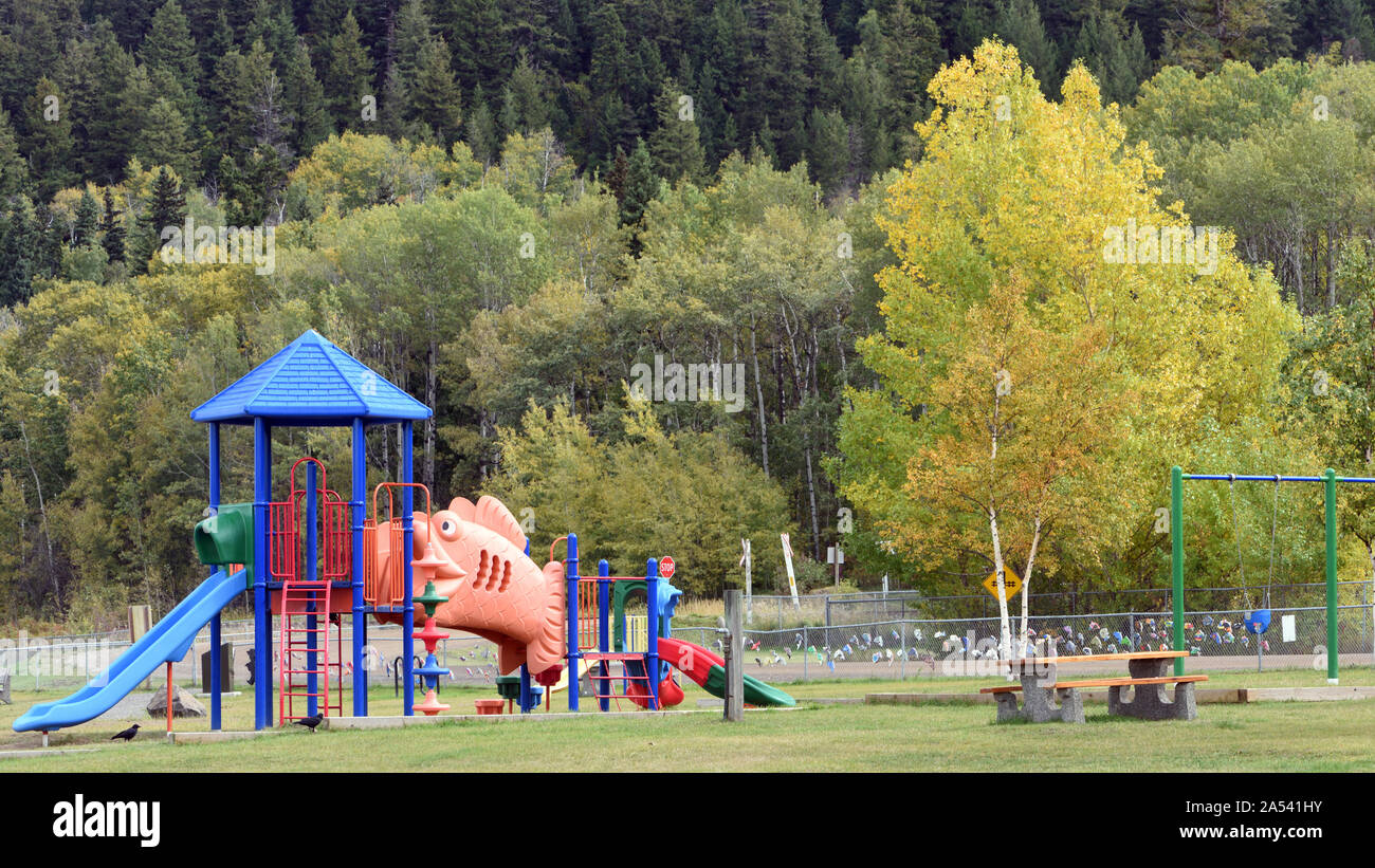 Children’s playground with autumnal trees. Terrace, British Columbia, Canada Stock Photo