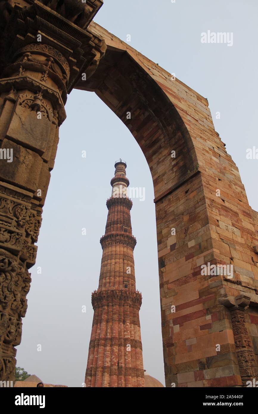 New Delhi, India - October 2014: Qutub minar, new delhi framed in a stone gate Stock Photo