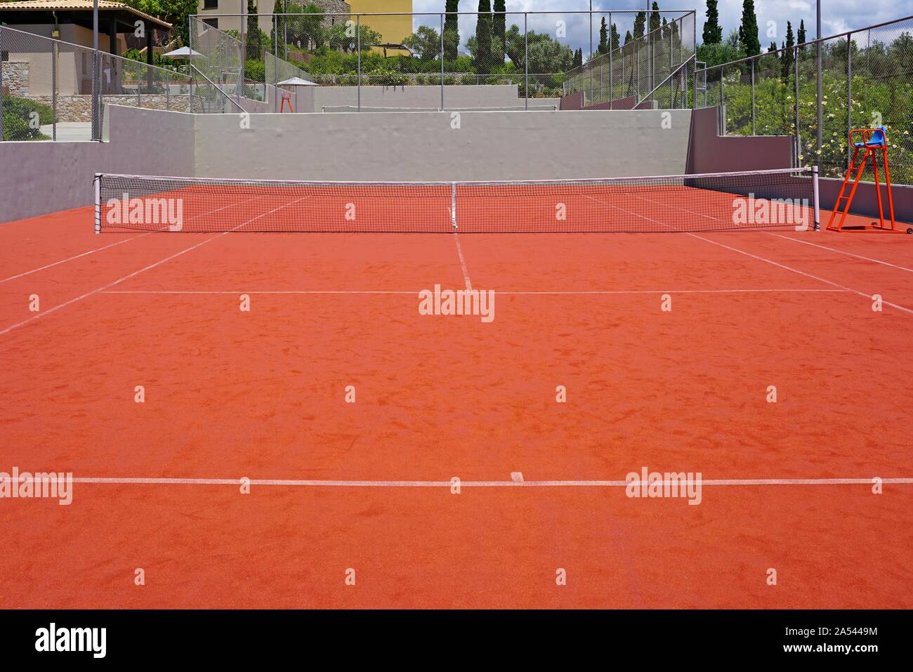 View of a red clay surface tennis court Stock Photo Alamy