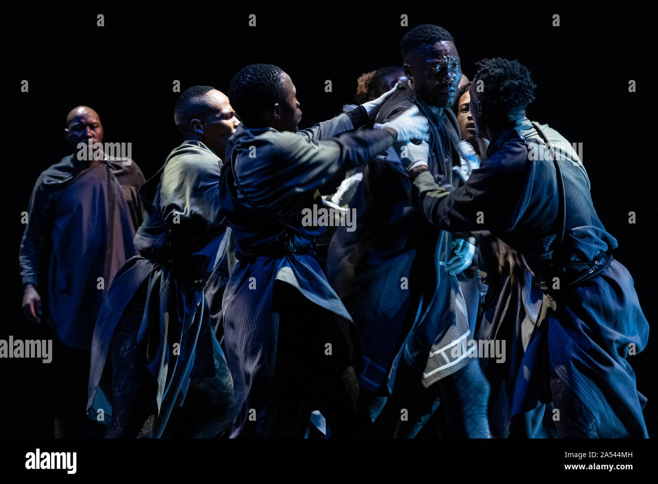 London, UK. 17th Oct 2019. Performance of “Cion - A Requiem to Ravel's Bolero” by Gregory Maqoma at Barbican Theatre, part of Dance Umbrella 2019. Joined by performers from Vuyani Dance Theatre, Maqoma embodies a professional mourner ‘Toloki’ - a character inspired by the protagonist of Zakes Mda’s novels Ways of Dying and Cion – which stands for hope against the darkness. The performance unfolds to Ravel’s Bolero, reinterpreted through percussion and voice by a South African Isicathamiya (a cappella) choir. Maqoma’s third Dance Umbrella appearance since 2015. Credit: Guy Corbishley Stock Photo