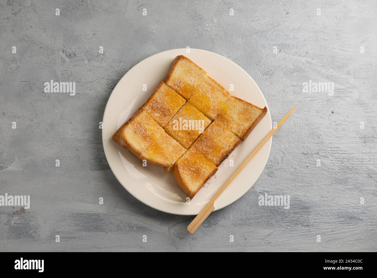 Bread toast with butter and condensed milk in plate. Selective focus Stock Photo