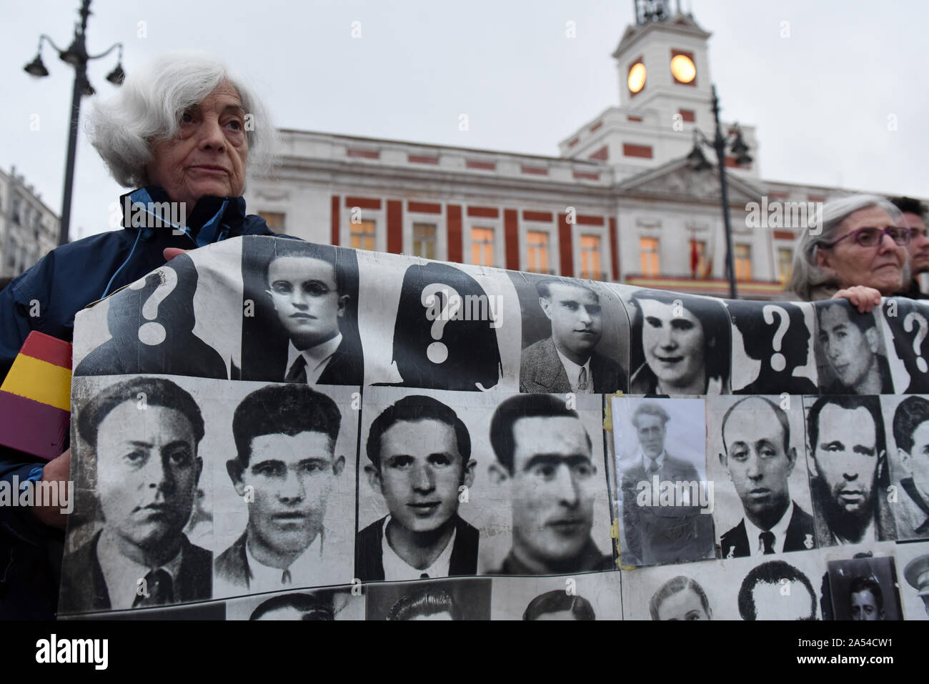 Madrid, Spain. 17th Oct, 2019. A protester holding a banner with pictures of people who went missing during the Spanish dictatorship of Francisco Franco (1936-1975).Around 50 people gathered in Madrid to protest against immunity for the crimes committed during the Francisco Franco's dictatorship, and to demand justice for victims and relatives. Spanish government has announced that the remains of Franco will be exhumed from Valle de los Caidos mausoleum, where they have lain since his death in 1975, the next week. Credit: SOPA Images Limited/Alamy Live News Stock Photo