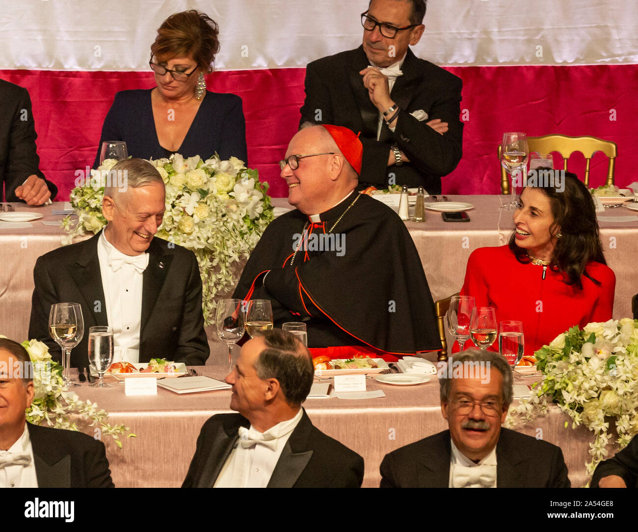 New York, NY - October 17, 2019: General Jim Mattis, Timothy Cardinal Dolan, Mary Ann Tighe attend 74th Annual Alfred E. Smith Memorial Foundation Dinner at Hilton Midtown Stock Photo