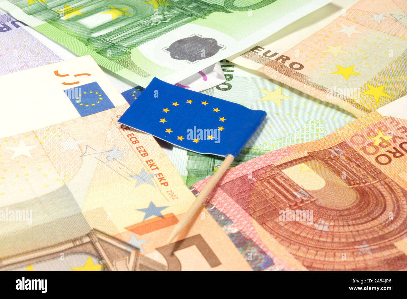 Many euro bills and flag of European Union Stock Photo