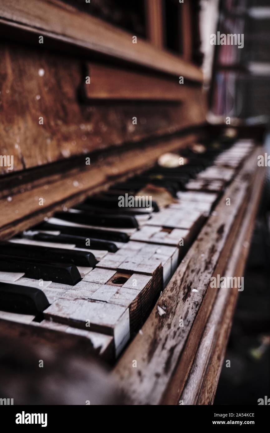 Vertical shot of an old wooden piano with a blurred background Stock Photo  - Alamy