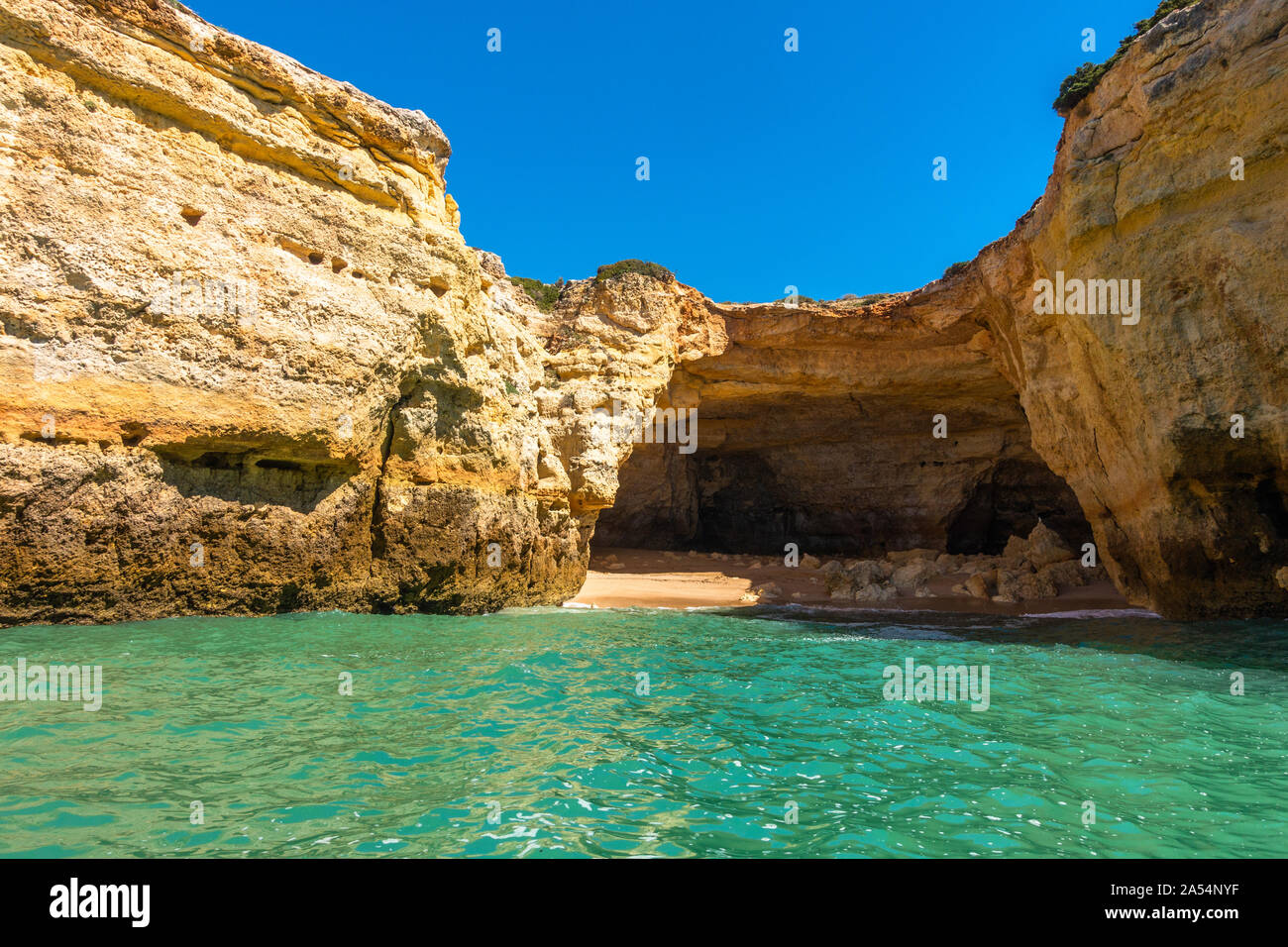 Spectacular cliffs overlooking turquoise sea waters near Benagil cave viewed from a boat, Algarve, Portugal Stock Photo