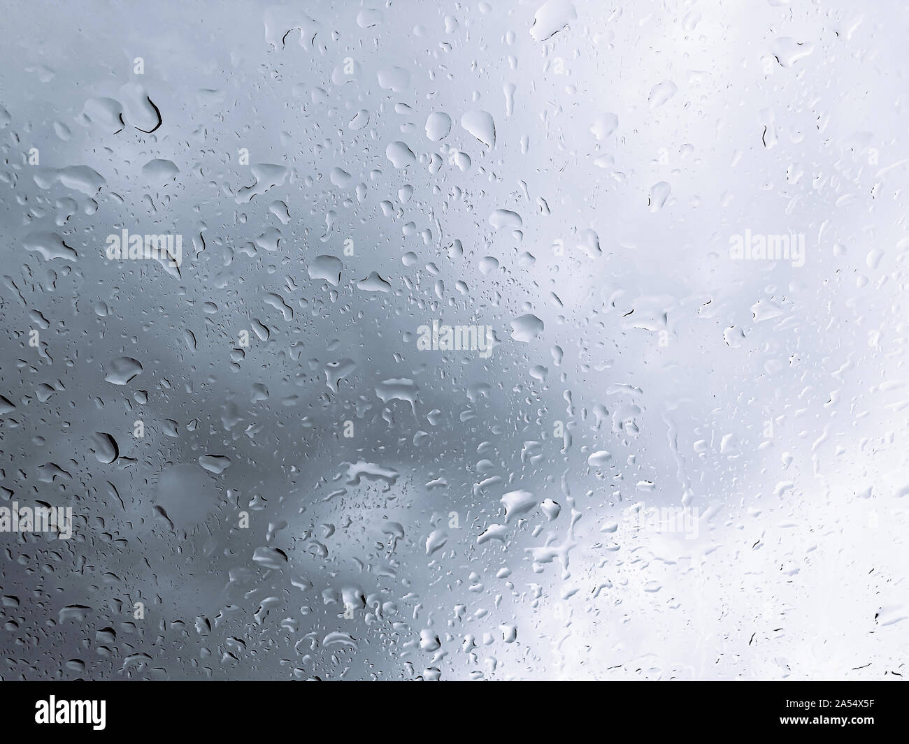 Rain water drop on glass window with dark clouds background - Rainy ...